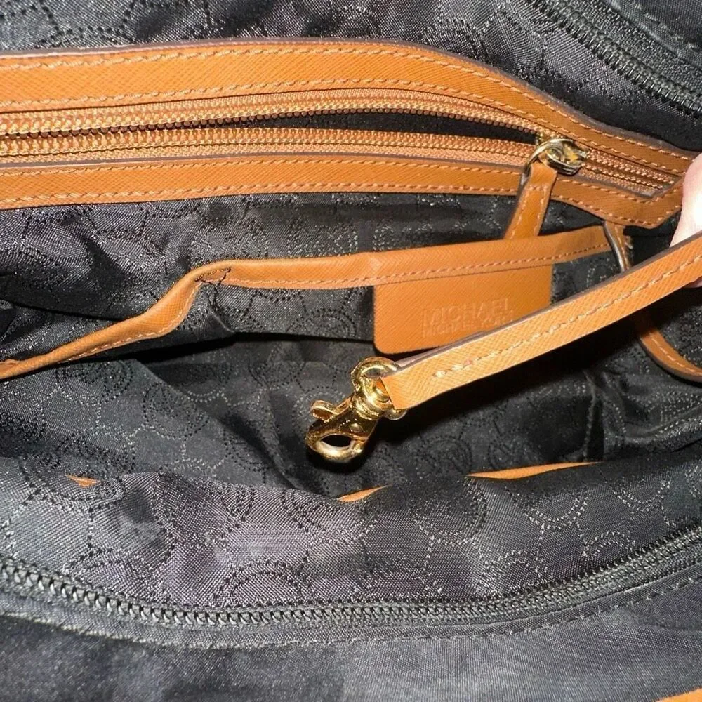 Michael kors black purse w/ tan trim 6 pockets